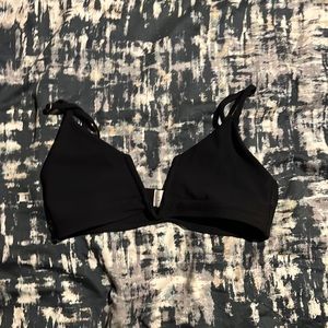 A black bikini top. Size medium. I do not know the cup size.